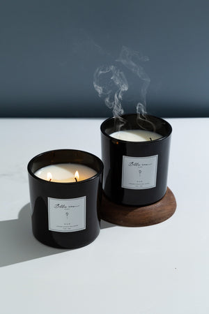 Oud candle in black vessel with a petrol blue background